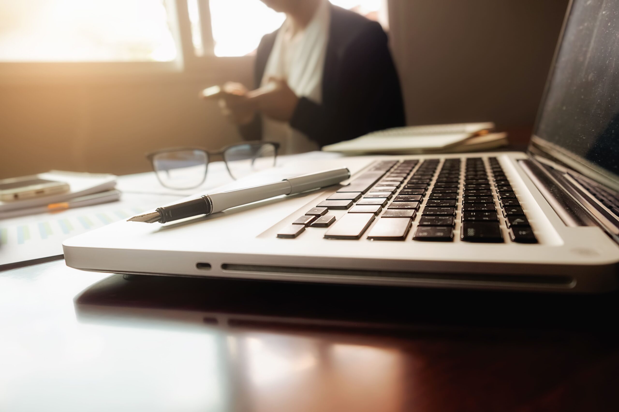 business concept with copy space office desk table with pen focus analysis chart computer notebook cup coffee desk vintage tone retro filter selective focus